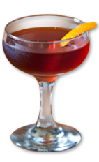 The 1873 Manhattan is a classy cocktail made from Wild Turkey bourbon, sweet vermouth, simple syrup, orange curacao, bitters and lemon, and served in a chilled champagne coupe.