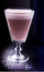 The Christmas Flip is a full bodied Christmas cocktail made in the traditional fashion. A pink colored cocktail made from cherry liqueur, almond milk, pimento dram and whole egg, and served in a chilled wine glass.