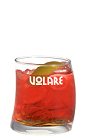 The Red Sunset drink recipe is a red colored cocktail made from Volare apricot brandy, vodka and sweet vermouth, and served over ice in a rocks glass garnished with a lime slice.