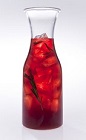The Winter Caipi Carafe is a red colored drink made from Leblon cachaca, rosemary, pomegranate juice, simple syrup and sparkling wine, and served from a carafe or pitcher. Recipe serves 4-8.