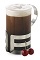 The Grown-up Cherry Hot Chocolate is a brown drink made from chocolate cherry liqueur, hot chocolate and whipped cream, and served in a warm coffee glass.