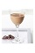 The Hazelnut Martini is a brown colored cocktail made from Bailey's Hazelnut flavored Irish cream, Smirnoff vodka and cocoa, and served in a chilled cocktail glass.